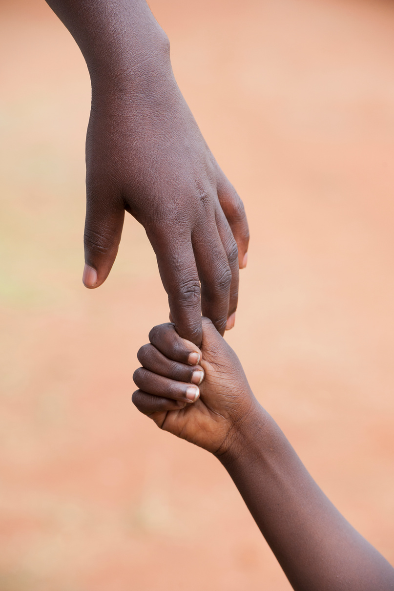 Female black hand holding  a child